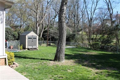 Fenced in backyard and building for storage.