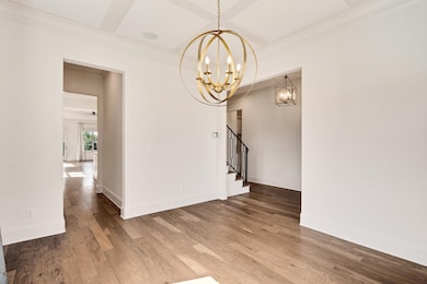 Unfurnished dining area featuring baseboards, stai