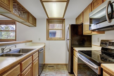 Kitchen with stainless steel appliances, a sink, h