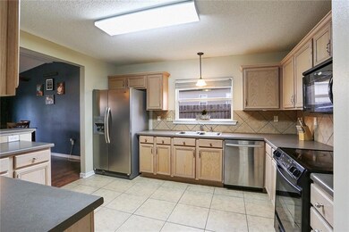 Large kitchen with bar.  Stainless steel dishwashe