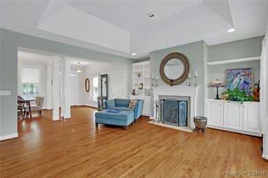  living room with a fireplace, light wood-style fl
