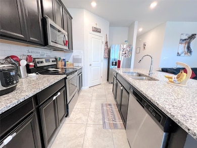 Kitchen featuring appliances with stainless steel