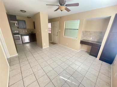 Kitchen featuring stainless steel appliances, lig