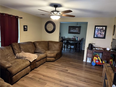 Living area featuring baseboards, light wood-styl