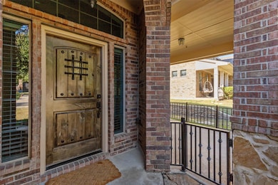 View of exterior entry with covered porch