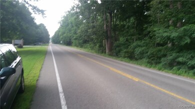 Lot is on the wooded side of the street.