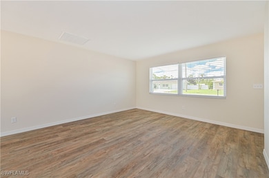 Unfurnished room featuring wood finished floors an