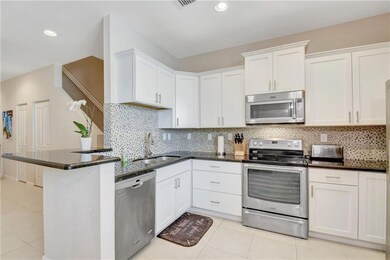 Great kitchen with full tile backsplash, granite c
