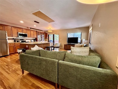 Living area with attic access, light wood-style fl