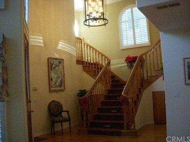 Custom wood flooring with wide, custom grand stairway (notice light in steps). 