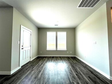 Empty room with baseboards and dark wood-style fl