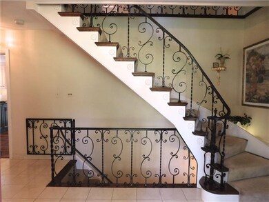 Gorgeous Italian ironwork graces the foyer stairca