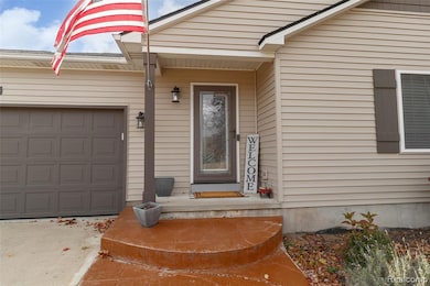 Doorway to property with a garage and concrete driveway