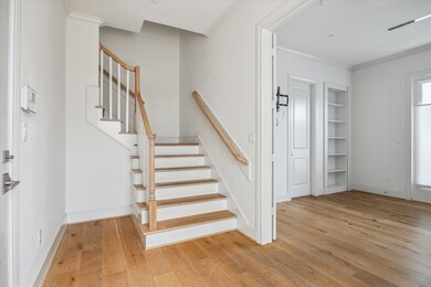 STAIRWAY WITH WOOD TREADS LEADS TO UPPER FLOORS -