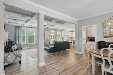Dining room with light wood-type flooring, coffere