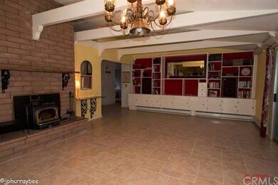 Huge family room with beamed ceiling. Wood burning