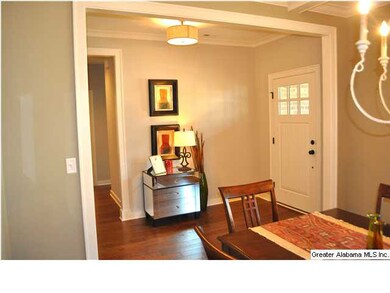 Pretty foyer upon entering has hardwood flooring