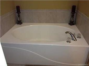 Master bath features a garden tub and separate til