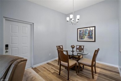 Dining area featuring a chandelier and hardwood / 