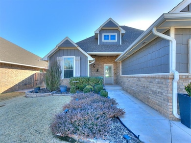 Property entrance featuring fence, brick siding, board and batten siding, and roof with shingles