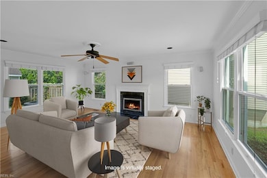 Living area with wood burning fireplace. (Photo is virtually staged).