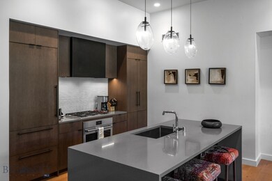 Kitchen with sink, stainless steel appliances, lig