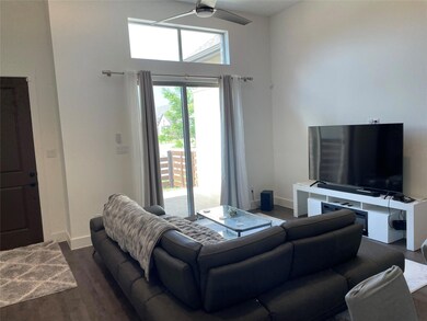 Living room with a high ceiling, plenty of natural