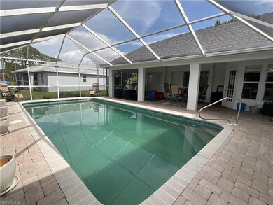 Swimming pool with a sunroom, glass enclosure, and a patio