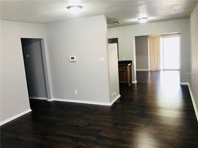 Living room view towards kitchen and back of home