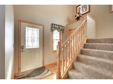 Light & bright 2-story foyer with hardwood floor. 