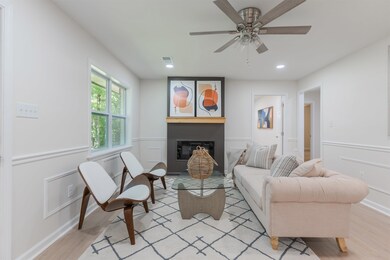 Living room with light hardwood / wood-style floor