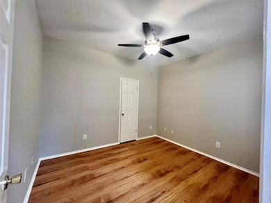 Unfurnished room with wood finished floors, ceili