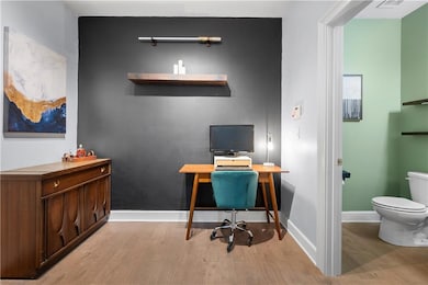Home office featuring wood finished floors and baseboards