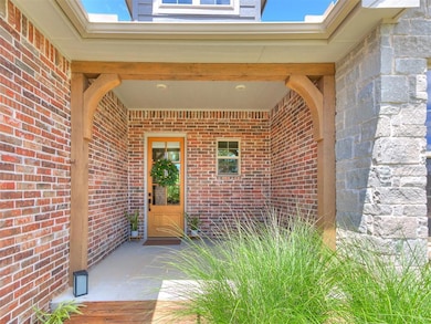 Doorway featuring crown molding, wood finished floors, and baseboards