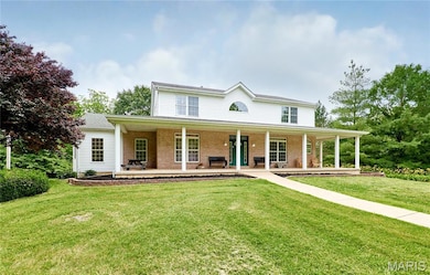 View of front of house with covered porch and front yard
