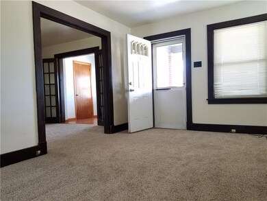 Living room view to front entry & porch, dining ro
