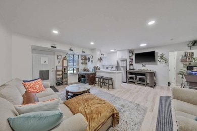 Living room with recessed lighting and light wood-style flooring