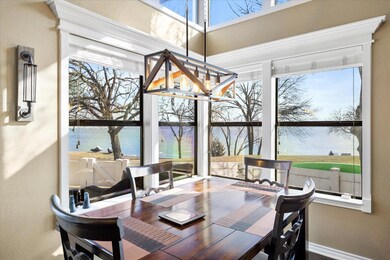 Dining room featuring a water view and a chandelie