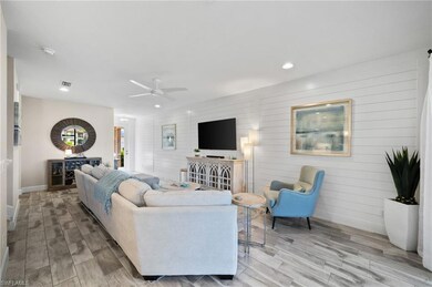 Living room featuring ceiling fan, light hardwood 