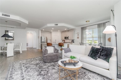 Living room with arched walkways, recessed lightin