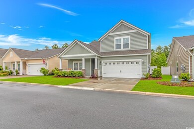 Craftsman-style house with a shingled roof, an att