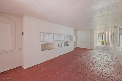 Hallway with mail area and a textured ceiling