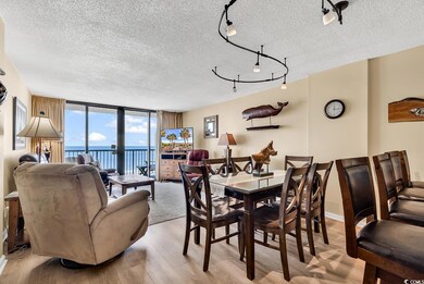 Dining area featuring a textured ceiling, track li