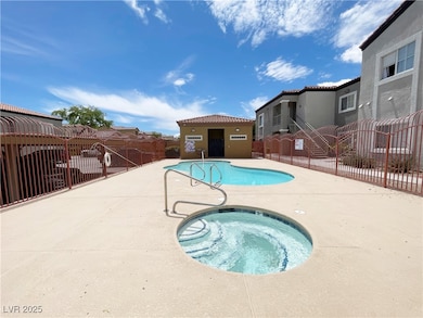 Community pool with a hot tub and a patio