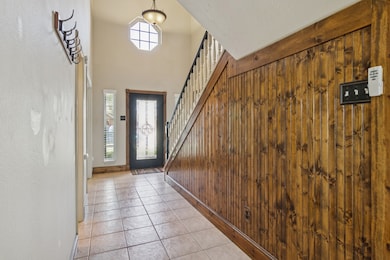 Entry way with tile floors. The beadboard adds a h