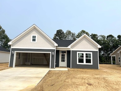 View of front of property featuring board and batten siding, a garage, and concrete driveway