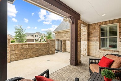 An extended covered Front Porch surrounded by stone and brick that was built to last, provides a perfect outdoor space to enjoy short visits with guests while the Courtyard gate keeps younger visitors safe when playing.