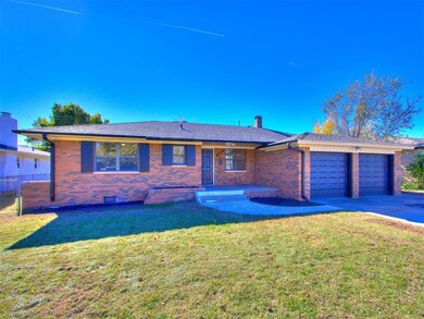 Ranch-style home with a front yard and a garage