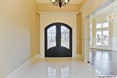 Lots of crown, trim work, huge door with functional glass panels. Gorgeous.