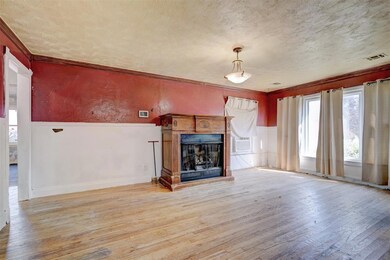 Unfurnished living room with ornamental molding, a